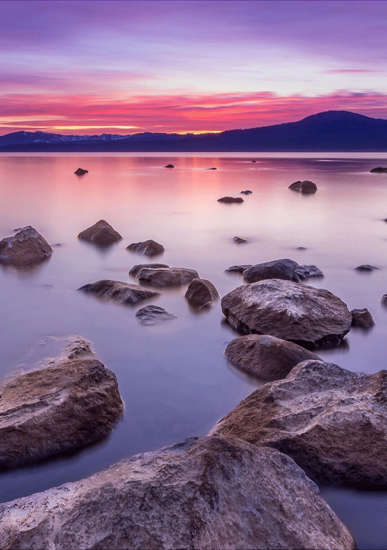 Scenic sunset with rocks in ocean